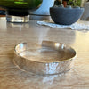 Silver bracelet on a wooden surface