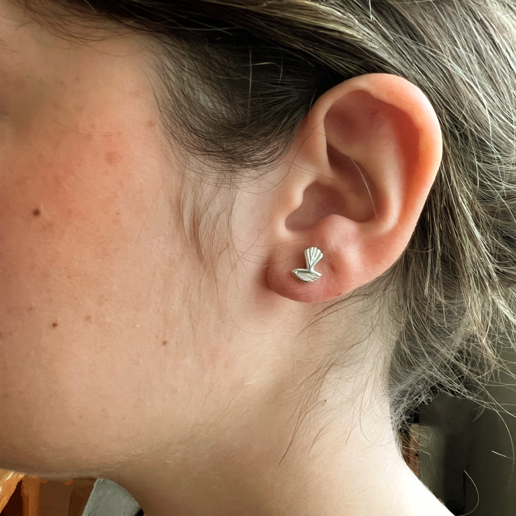 Ear with a petite bird stud earring