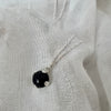 Necklace with a dark blue stone pendant on a white fabric background