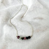 Necklace with small beads on a white fabric background