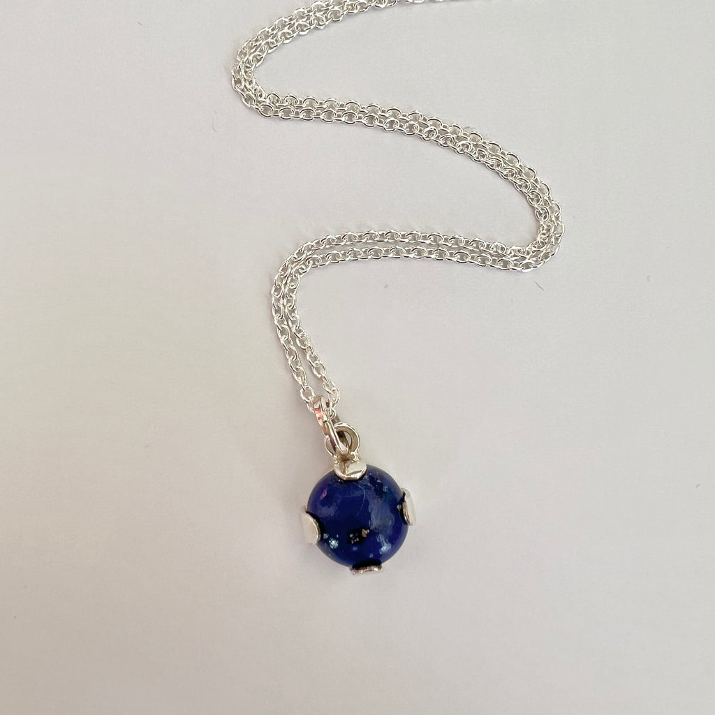 Necklace with a blue pendant on a white background