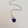 Necklace with a blue pendant on a white background