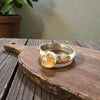 Silver ring with an orange stone on a wooden surface