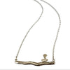 Silver necklace with a branch and bird pendant on a white background