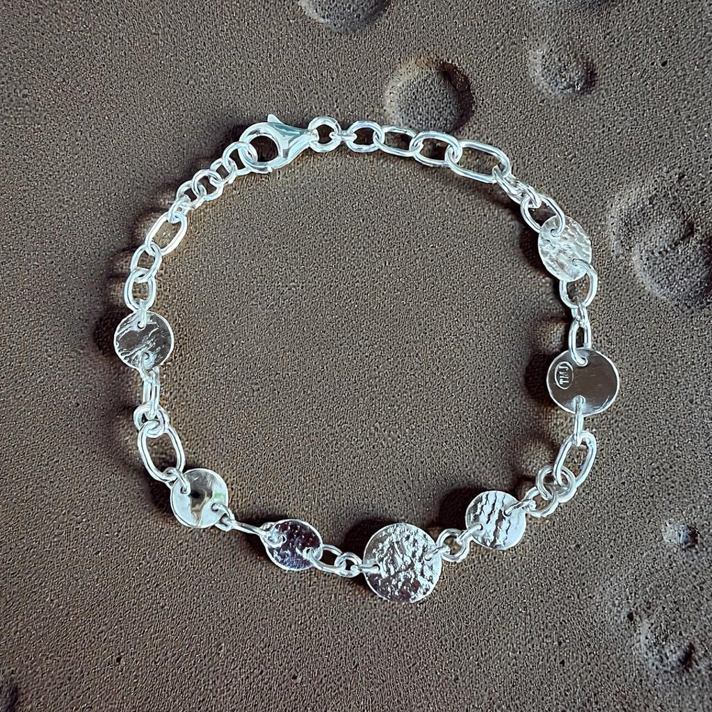 Silver bracelet on a textured surface