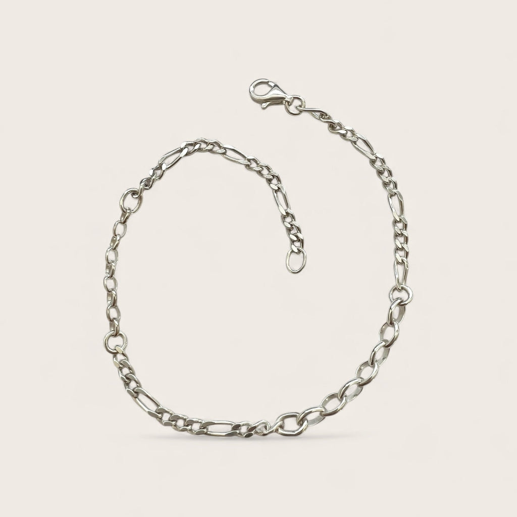Silver chain bracelet on a light beige background