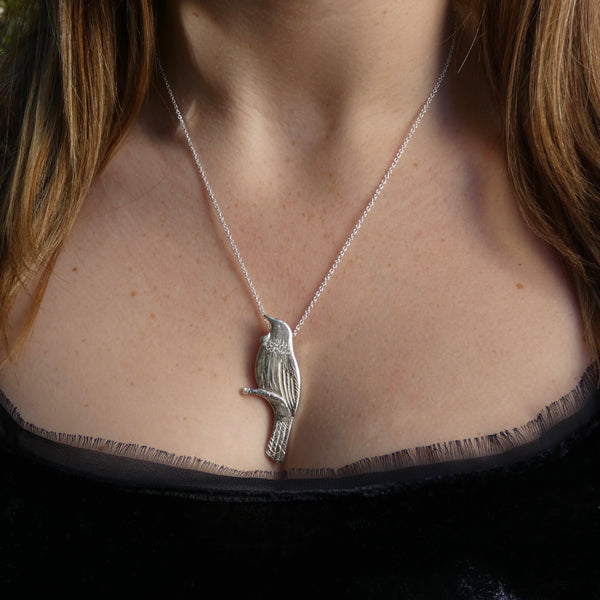 Photo of girls neck wearing Silver Tui bird pendant on silver chain, 54mm x 22mm x 3mm,15.2g, handmade by Tania Mallow Jewellery
