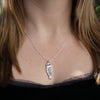 Photo of girls neck wearing Silver Owl, Ruru,  Morepork pendant on silver chain, hand carved in wax then cast in silver, made by Tania Mallow Jewellery