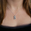Photo of girls neck wearing small tiki pendant, carved in wax then cast in silver, on 45cm silver chain, handmade by Tania Mallow Jewellery