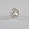 Silver ring 11mm wide with dimpled texture, handmade by Tania Mallow Jewellery