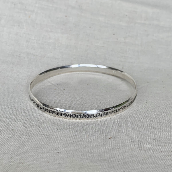 Solid sterling silver bangle with lace texture finish, 5mm wide, handmade by Tania Mallow Jewellery
