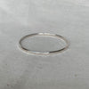 Solid sterling silver bangle with hammered texture finish, 3mm wide, handmade by Tania Mallow Jewellery