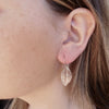 Photo of girls profile wearing Silver leaf earrings with leaf skeleton imprint, 20mm x 12mm, silver hooks, handmade by Tania Mallow Jewellery
